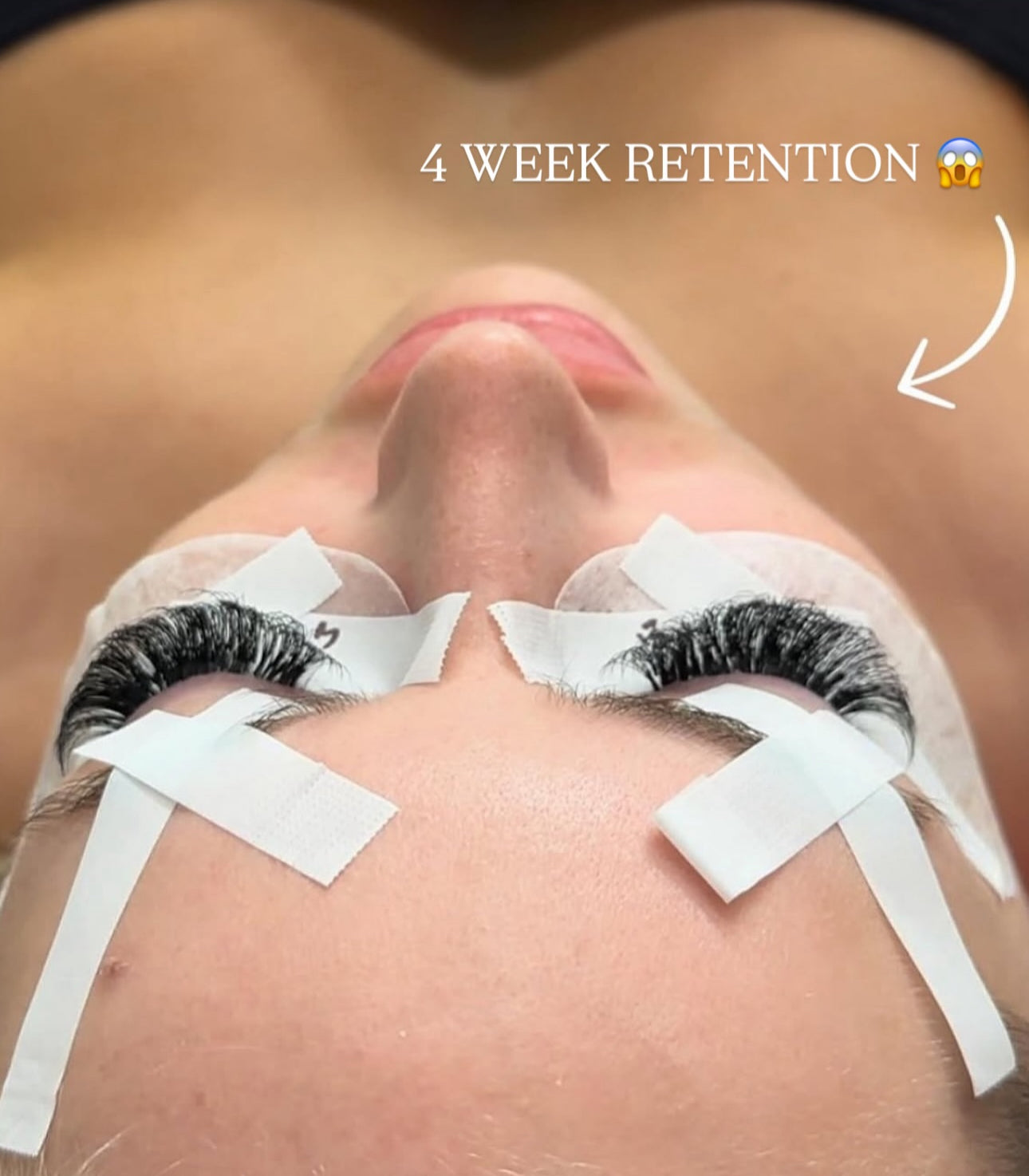Close-up of a person with eyelashes and adhesive tape, with text indicating '4 Week Retention'.